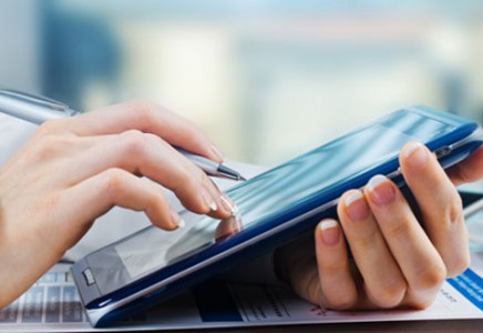 person touching a tablet screen