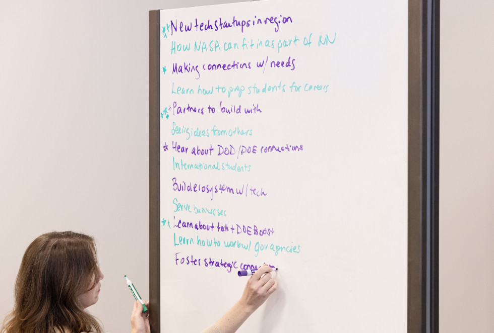 Sandia National Laboratories Business Development Manager Kelli Howie records responses from the group discussions during the Department of Energy (DOE) Boost Platform Workshop in Newport News