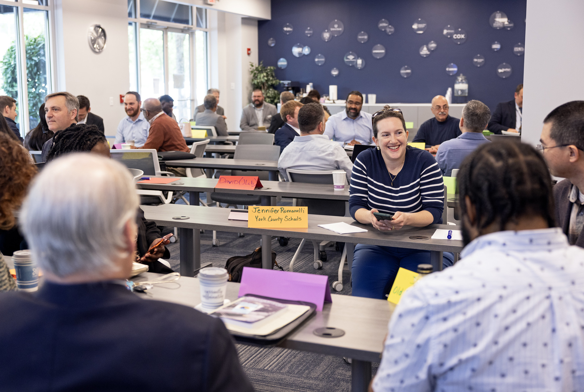 Jefferson Lab Chief Innovation Officer Marla Schuchman, center, smiles with her group members during the Department of Energy (DOE) Boost Program meeting held in Newport News, Va., on Thursday, April 25, 2024.